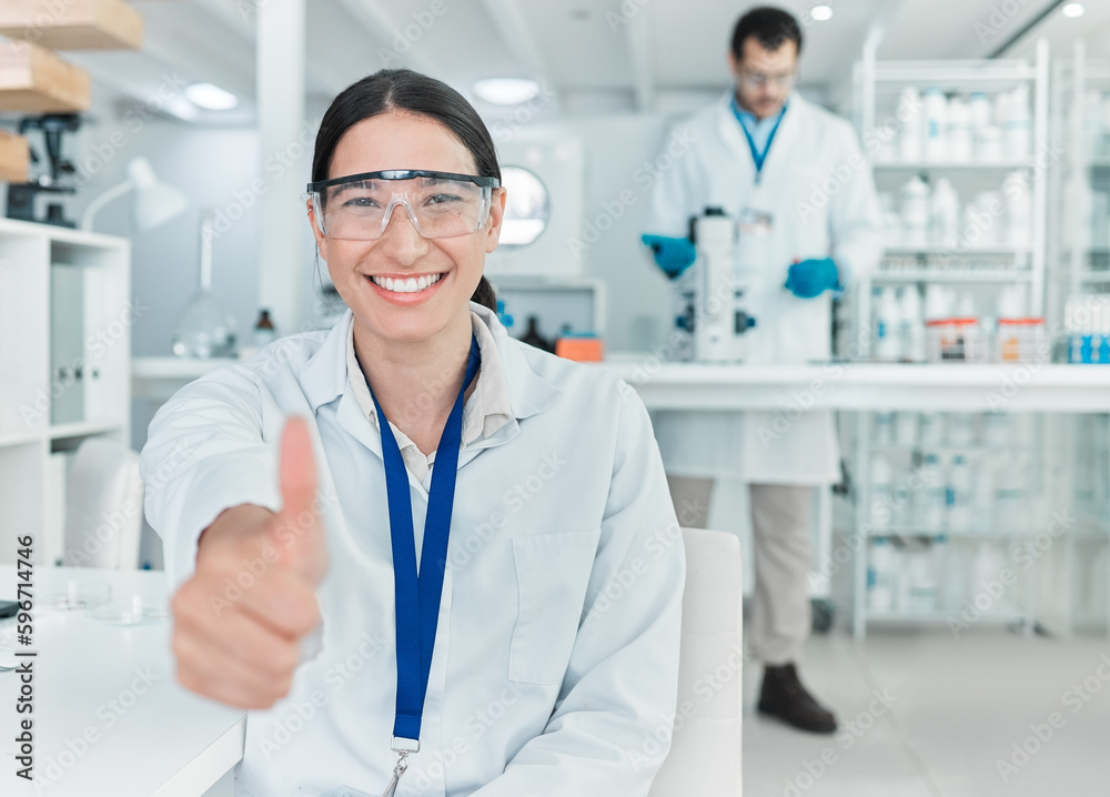 Poster my experiment has been a roaring success. portrait of a young scientist showing thumbs up in a lab.