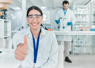 My experiment has been a roaring success. Portrait of a young scientist showing thumbs up in a lab.