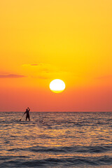 silhouette of a person with a surfboard