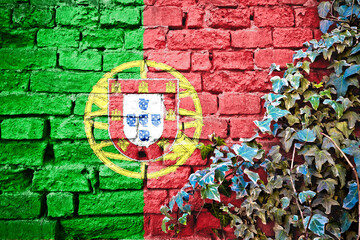 Portugal grunge flag on brick wall with ivy plant