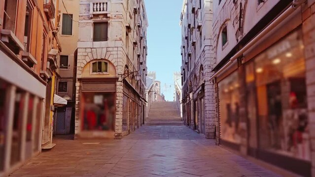Motion along small street with closed shops to Rialto bridge