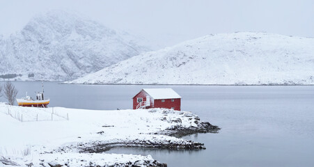 Red rorbu house in winter, Lofoten islands, Norway