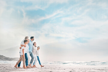 Enjoying lifes design. Shot of a beautiful family bonding while spending a day at the beach together.