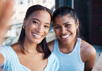 Shes always got my back. Shot of two young female friends taking a selfie at a cafe.