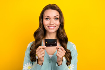 Photo advert of young cheerful lady promoter hold black premium plastic card demonstrate wireless...