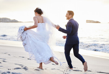 Im looking forward to years of adventure by your side. Shot of a young couple on the beach on their wedding day.