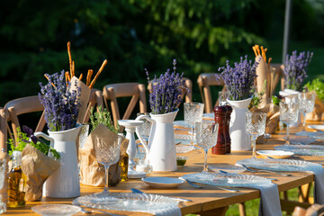 Beautiful outdoor celebration table green background with lavender decoration
