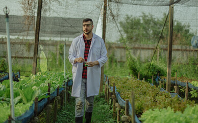 To assess the efficiency of modern greenhouse farming management, agricultural research expert inspect and collect data on crops, water, air, and insects. Performing regular laboratory procedures.