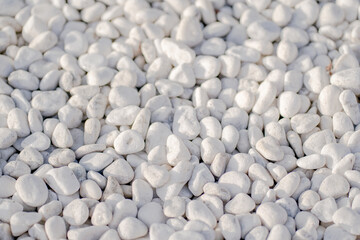 White pebbles rock texture on the ground for background. 
