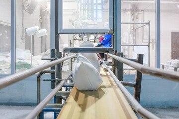 Factory workshop with bags on the conveyor line.