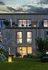 Reihenhaus mit Holzfassade mit Blick auf die Terrassenseite am Abend - 596736356