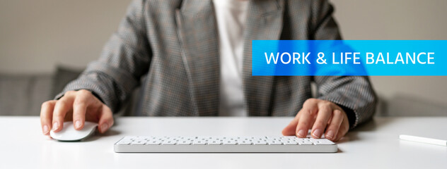 Text Work and Life Balance and person working at the desk in office on background.
