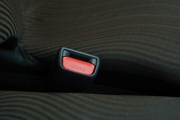 The red seat belt slot with the text 