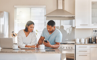 Calculating our monthly expenses. Shot of a couple going over paperwork together at home.