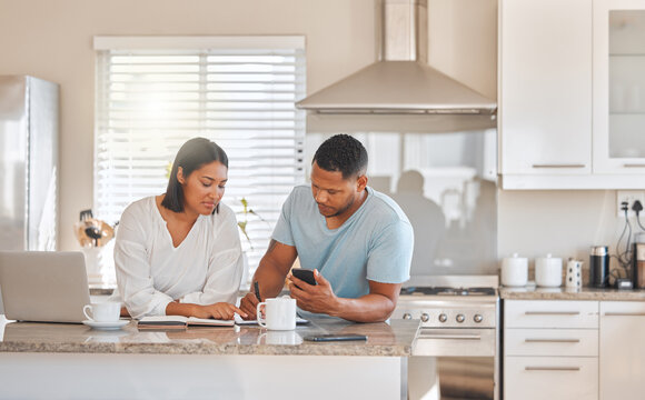 Calculating Our Monthly Expenses. Shot Of A Couple Going Over Paperwork Together At Home.