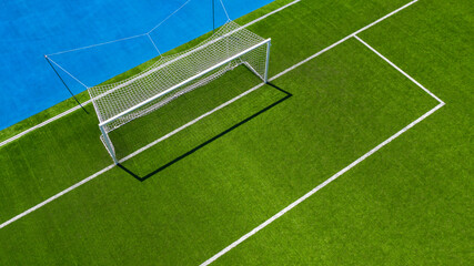 Aerial closeup of the penalty area on an empty synthetic grass soccer field. © Stefano Tammaro