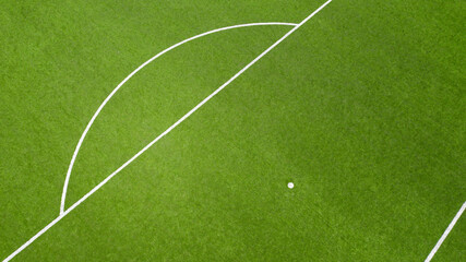 Aerial closeup of the penalty spot on an empty synthetic grass soccer field. Here a penalty is...