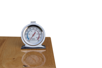 Close up of oven thermometer on on wooden table on white background. PNG