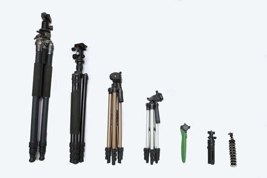 A variety of sizes of tripods for many photographers.