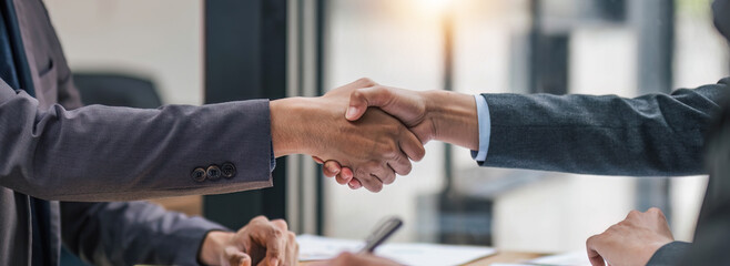 Business handshake for teamwork of business merger and acquisition,successful negotiate,hand shake,two businessman shake hand with partner to celebration partnership and business deal concept. - obrazy, fototapety, plakaty