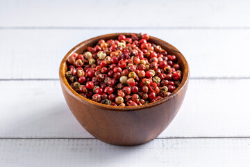 Red pepper seeds bowl. 45 degrees studio shoot on light wooden white background.