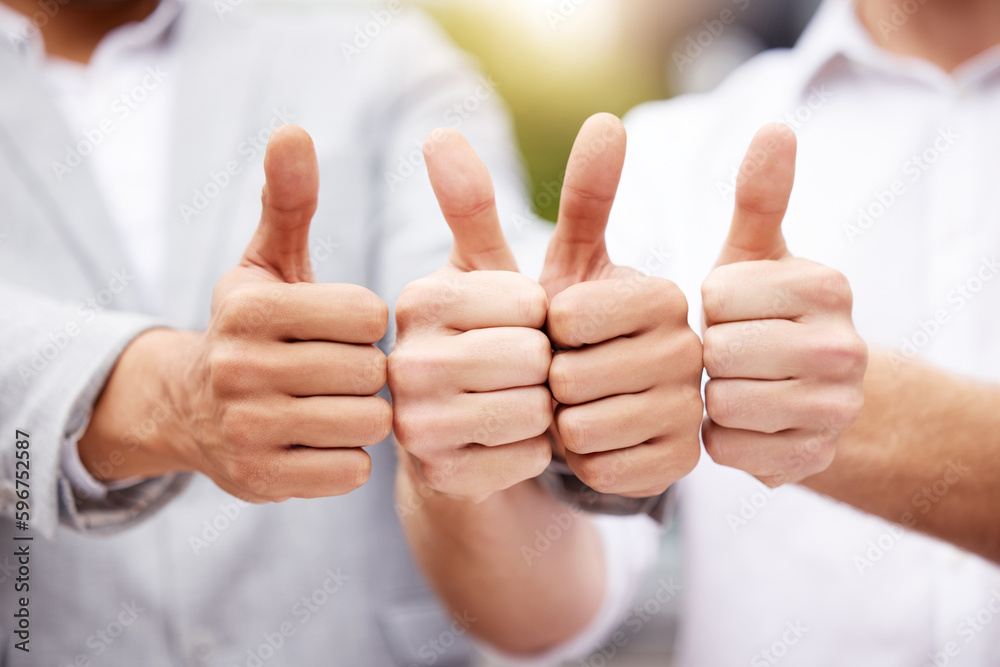 Poster Put a thumb up if you like it. Shot of two unrecognizable businesspeople showing a thumbs up outside.
