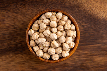 Chick pea uncooked beens. Studio shoot isolated on wooden background. Up view shoot.