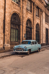 Fototapeta na wymiar Old American car in the historic streets of Havana in Cuba with old buildings