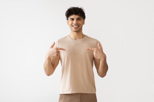 Middle Eastern Man Pointing Fingers At Himself Over White Background