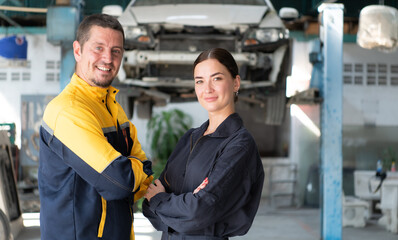 Portrait of engineer and auto mechanic with working on engine repairs in car garages