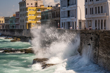 Waves splash on the Malecon sea wall in la Havana Cuba