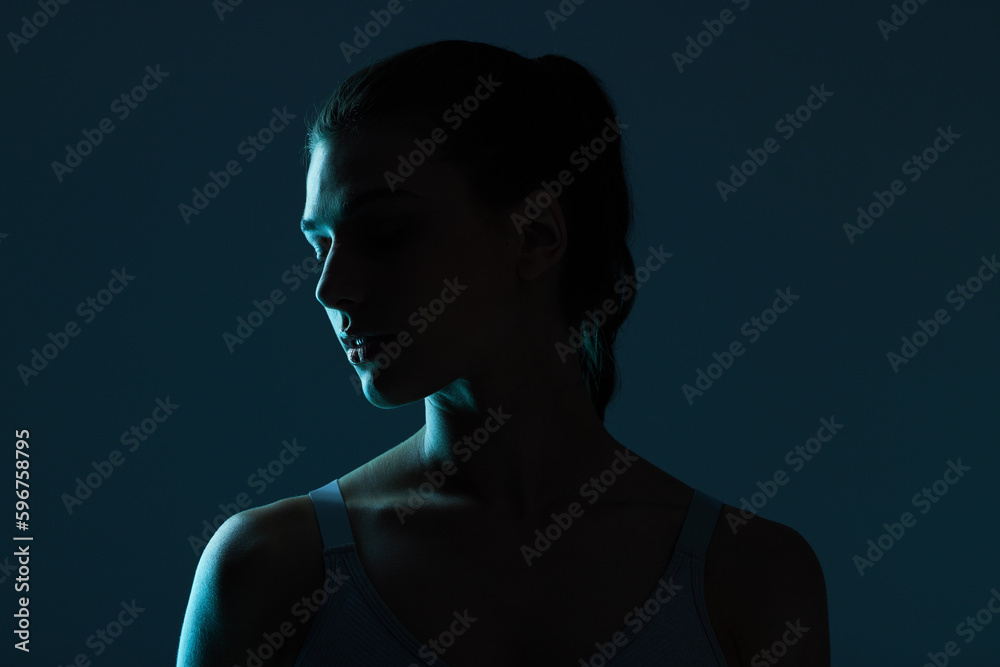 Wall mural let her light up the darkness. cropped shot of an attractive young woman posing in studio against a 