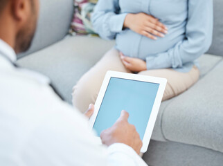 You have to rest well before the baby arrives. Closeup shot of a doctor using a digital tablet during a consultation with a pregnant woman in a medical office.