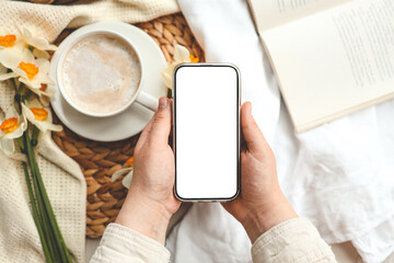 Hands with phone with isolated screen on background of spring composition