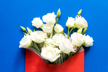 Composition with envelope and beautiful spring flowers.Spring invitation. Craft paper envelop. Happy birthday congratulation. copy space