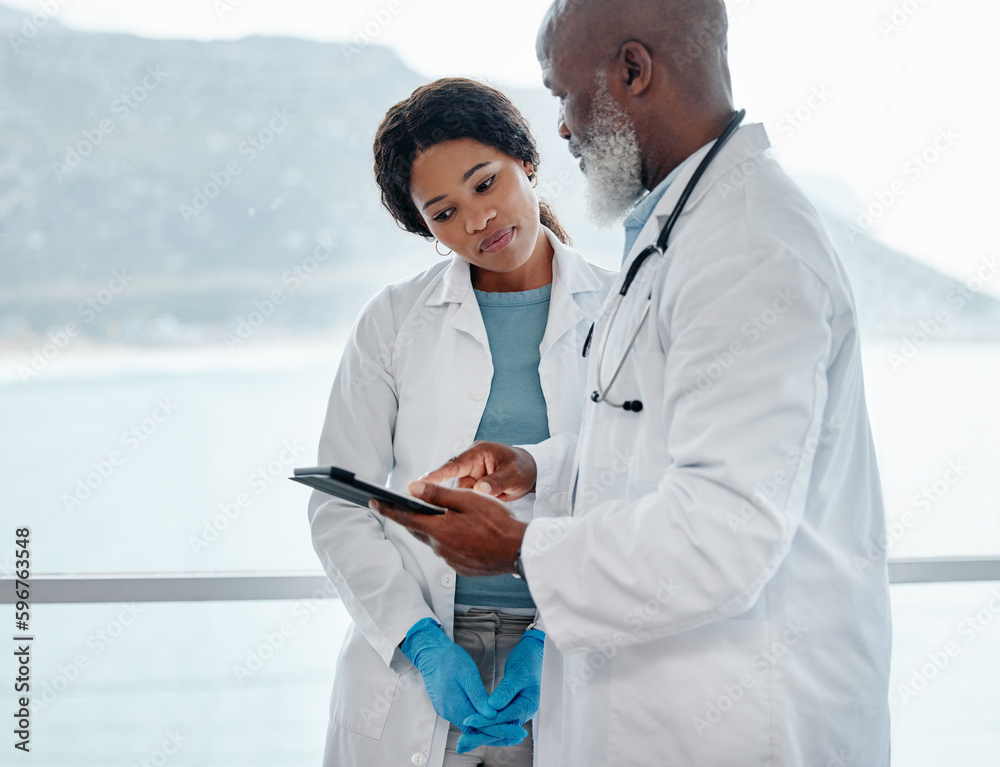 Poster dedicated to saving lives at all costs. shot of two doctors using a digital tablet together in a med