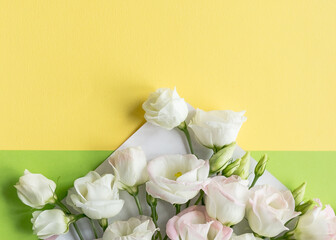 Composition with envelope and beautiful spring flowers.Spring invitation. Craft paper envelop. Happy birthday congratulation. copy space