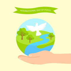Peace Day composition with the planet and white dove in hands