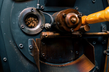 Coffee beans are rotated in a machine for roasting coffee beans close-up of craft coffee production