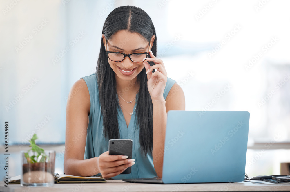 Poster Smiling ambitious mixed race businesswoman sitting alone at a desk in the office and browsing the internet on her cellphone. Hispanic professional using technology to connect and network with clients