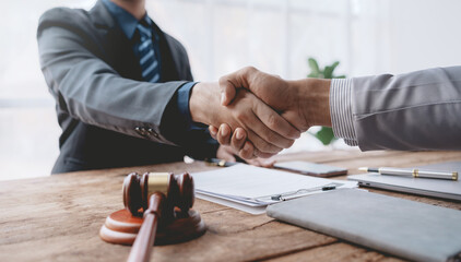 Businessman handshake to seal a deal with his partner lawyer or attorney discussing a contract agreement.