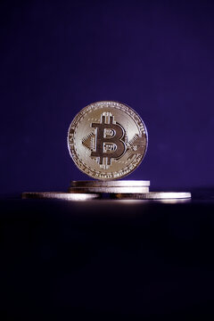 gold bitcoin on black background with selective focus	