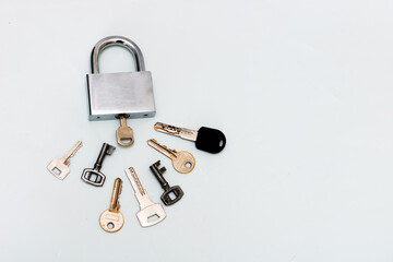 padlock with many keys on a white background with copy space