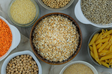 Oat flakes in bowl. Various vegetarian organic products. Grocery. Top view.