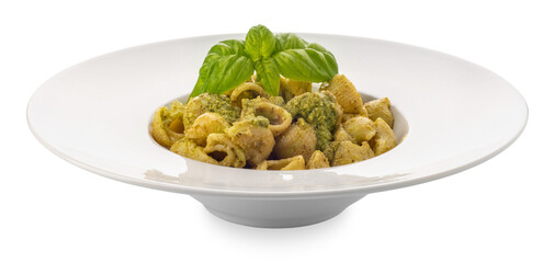 Macaroni pasta with pesto in a white dish with basil leaves, pesto is a typical Genoese sauce of basil, pine nuts, olive oil and parmesan cheese. 