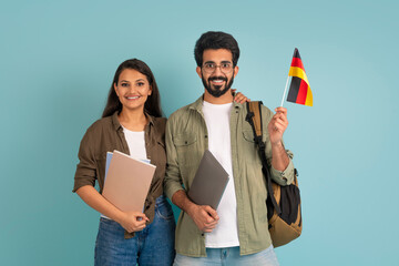 Happy young indian couple students with flag of Germany - obrazy, fototapety, plakaty