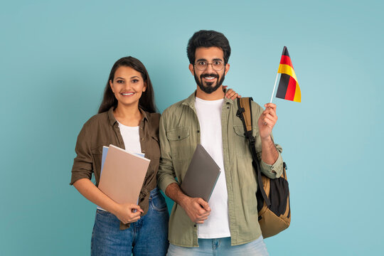 Happy young indian couple students with flag of Germany