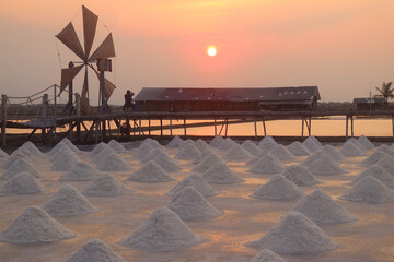 Fantastic View of Harvested Salt Farm with Golden Red Sunset Reflection, Petchaburi Province of...