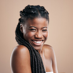 I wear my braids like a crown. Cropped portrait of an attractive young woman posing in studio against a brown background.