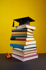 Stacked book with graduation cap